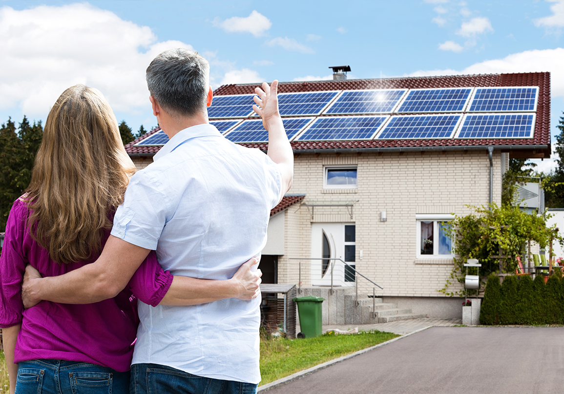 Residential homeowners with solar panels on their roof.